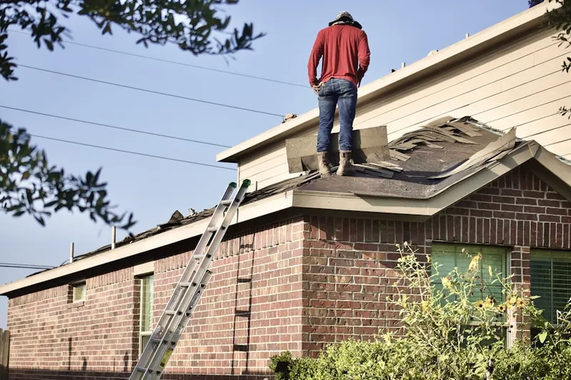 Professional roofer working on a residential roof in Bryn Mawr Place